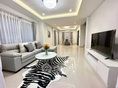 Spacious modern living room with elegant decor and open dining area