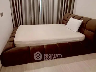 Luxurious bedroom with plush brown bed and elegant curtains