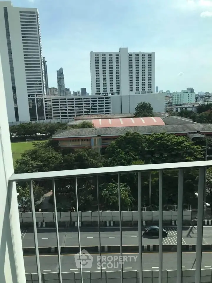 Stunning city view from high-rise balcony overlooking urban landscape.