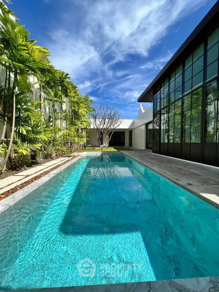 Luxurious modern home with stunning private pool and lush greenery