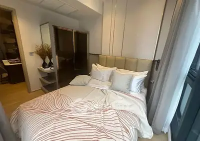 Cozy bedroom with modern decor and ample natural light