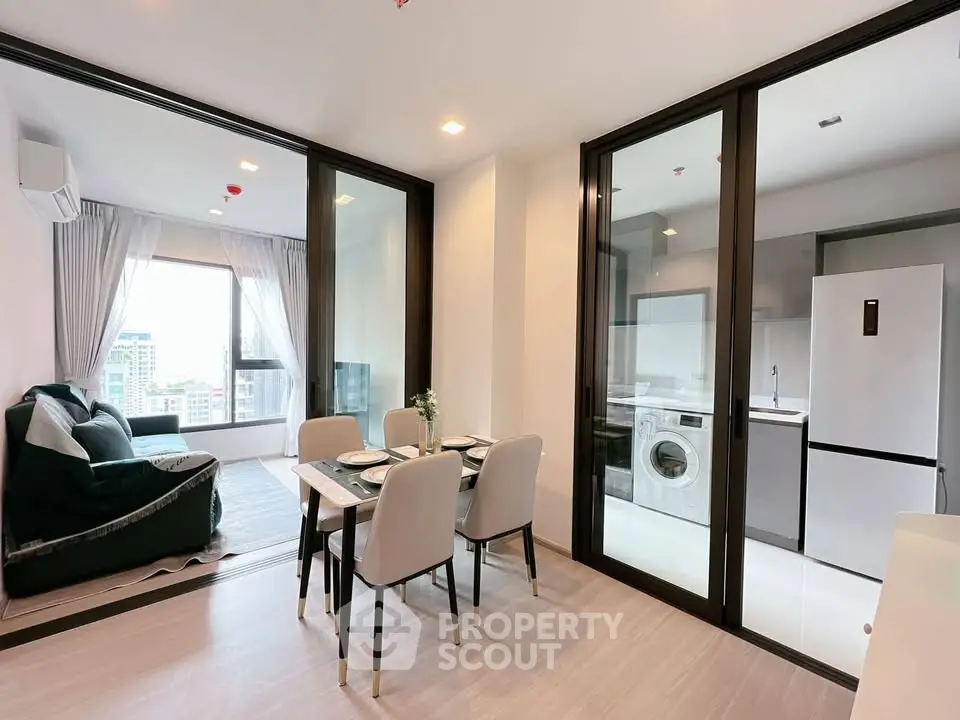 Modern open-plan living and dining area with glass partition and city view