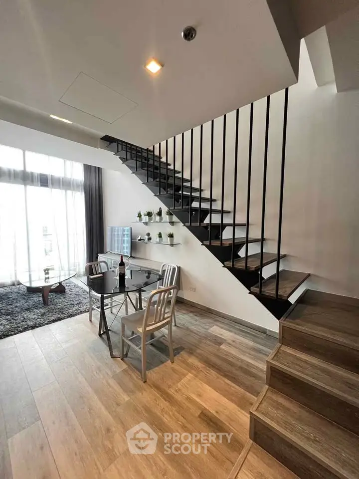 Modern duplex living room with stylish staircase and elegant decor
