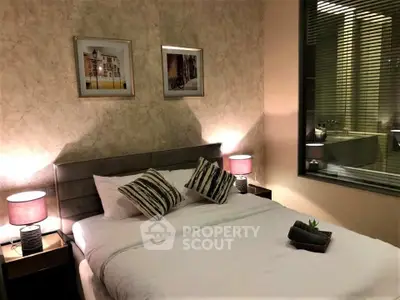 Cozy bedroom with modern decor and ambient lighting, featuring a comfortable bed and stylish artwork.
