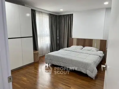 Spacious bedroom with modern design and wooden flooring