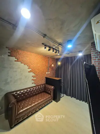 Stylish industrial-style living room with exposed brick and leather sofa