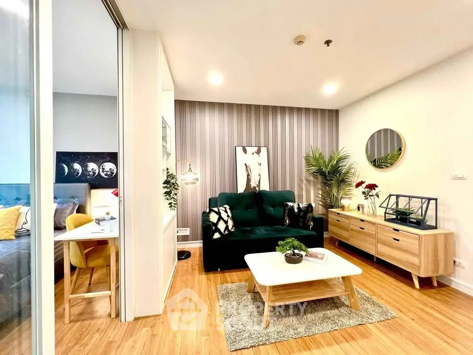 Stylish modern living room with green sofa, wooden flooring, and elegant decor in a cozy apartment.