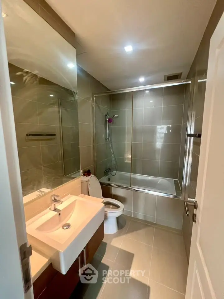 Modern bathroom with sleek fixtures and glass shower enclosure