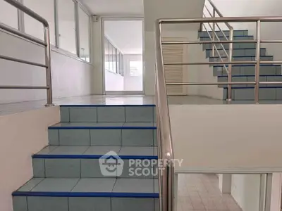 Modern building interior with sleek staircase and glass partitions