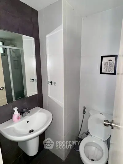 Compact modern bathroom with sleek fixtures and minimalist design