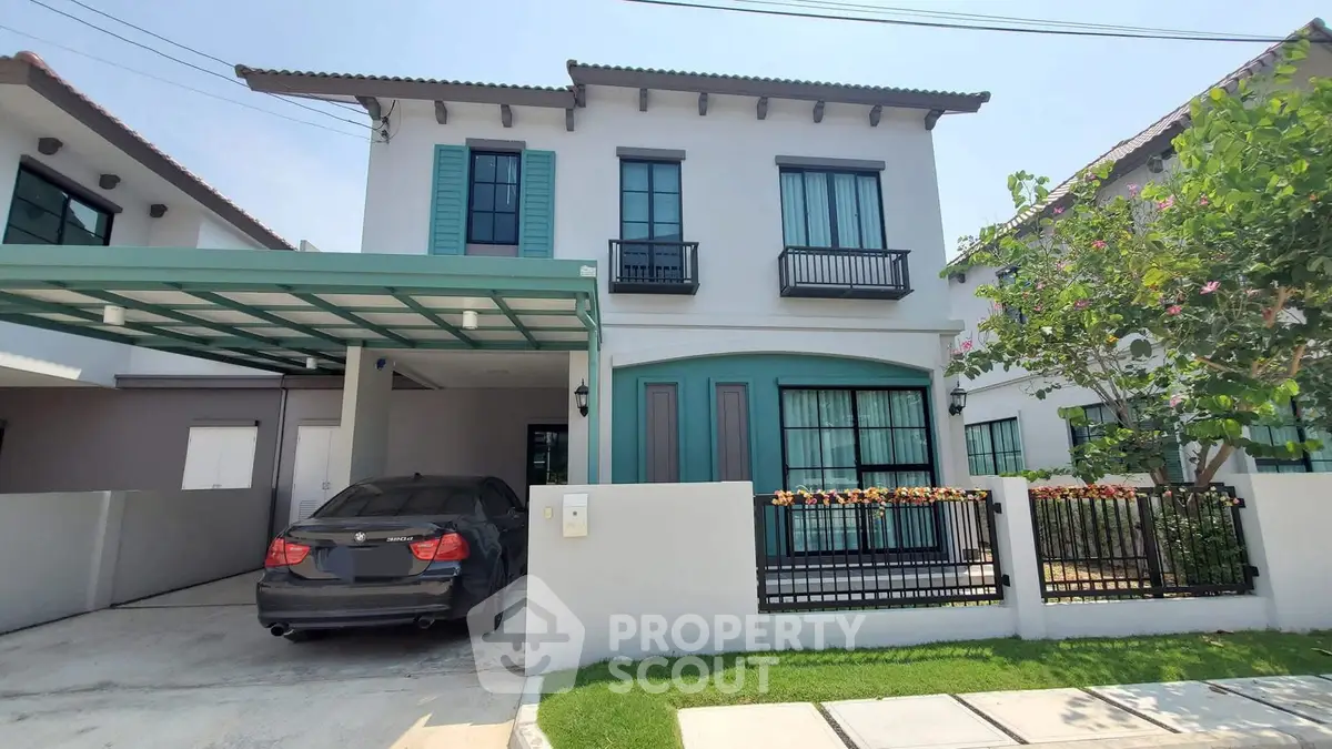 Charming two-story house with carport and lush garden in serene neighborhood.