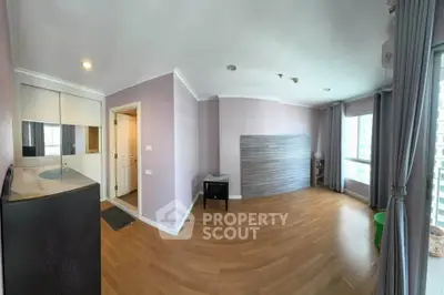 Spacious living room with wooden flooring and large windows in modern apartment