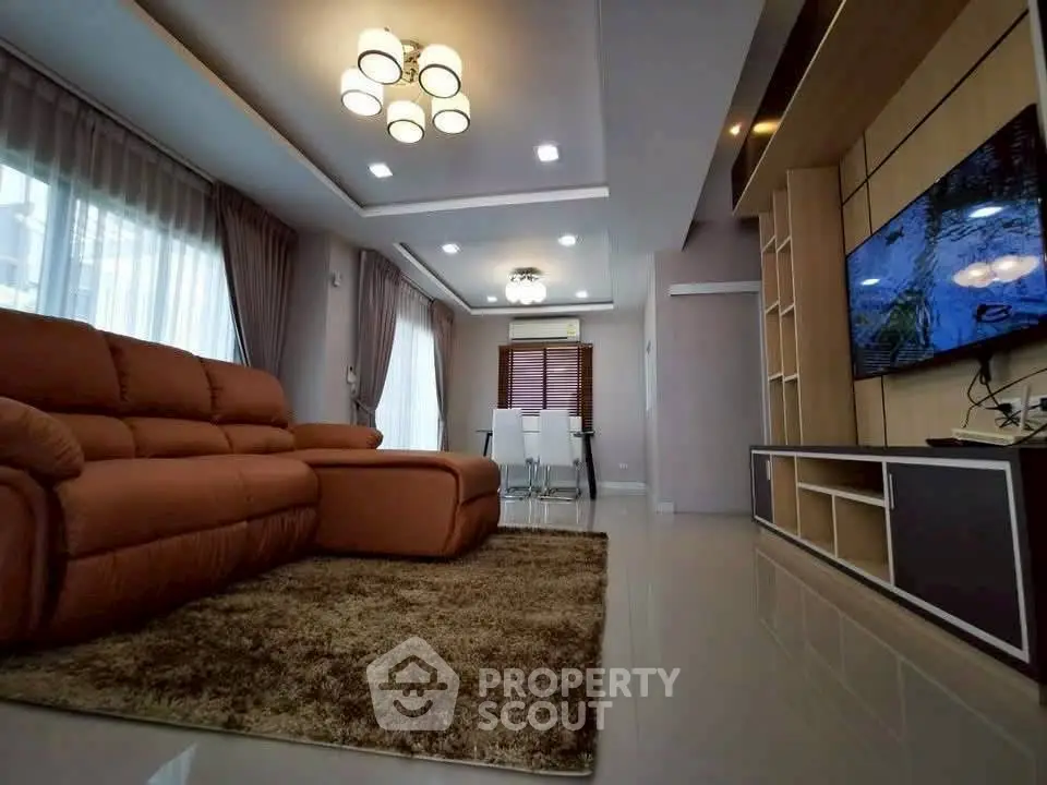 Spacious modern living room with plush sofa and elegant lighting