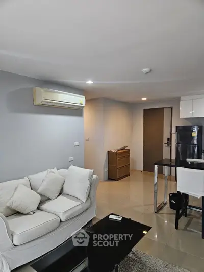 Modern living room with sleek furniture and air conditioning in a stylish apartment.