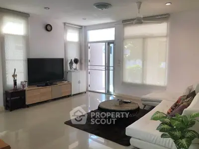 Spacious modern living room with large windows and stylish furniture