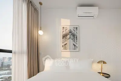 Modern bedroom with stylish decor and city view, featuring elegant lighting and air conditioning.