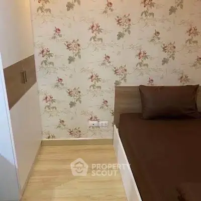 Cozy bedroom with floral wallpaper and modern wooden furniture