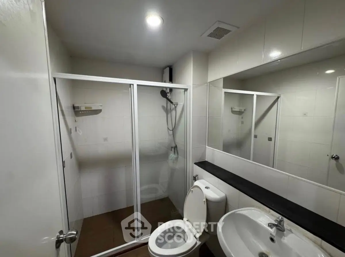 Modern bathroom with glass shower and sleek fixtures