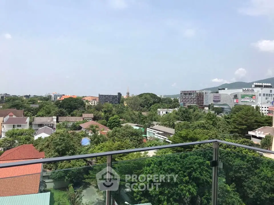 Stunning cityscape view from a modern balcony overlooking lush greenery and urban skyline.