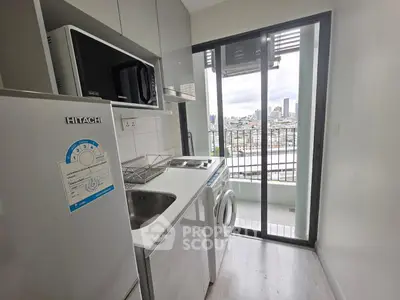 Modern kitchen with appliances and city view from balcony