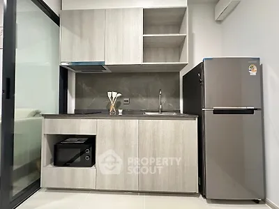 Modern compact kitchen with sleek cabinetry and stainless steel appliances