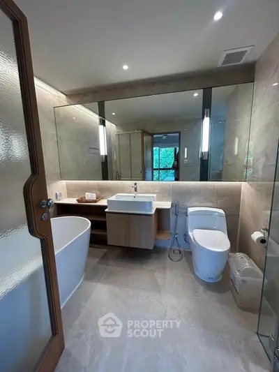 Luxurious modern bathroom with elegant fixtures and a spacious bathtub, perfect for relaxation.