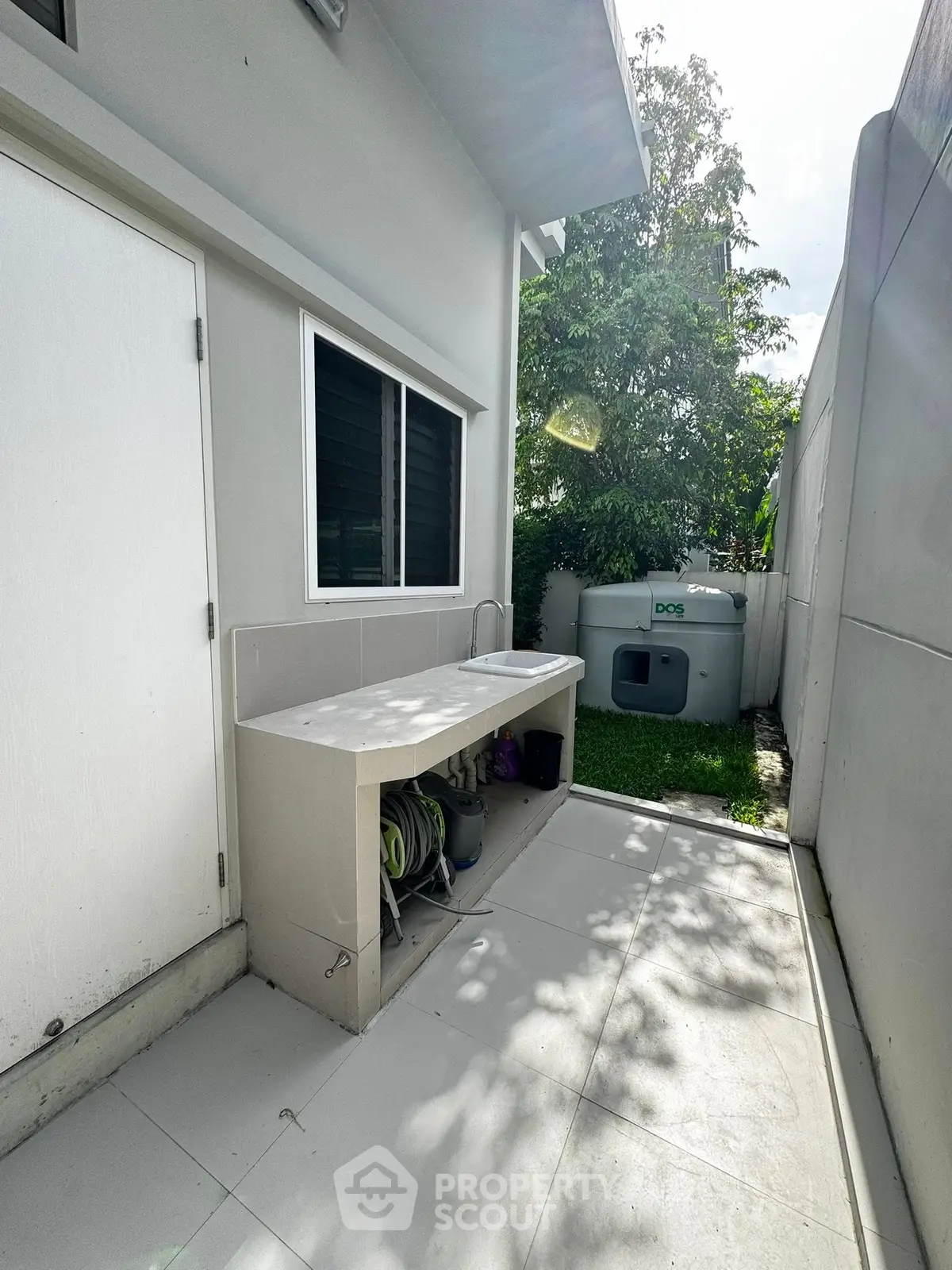 Modern outdoor utility area with sleek sink and storage, perfect for gardening or maintenance tasks.