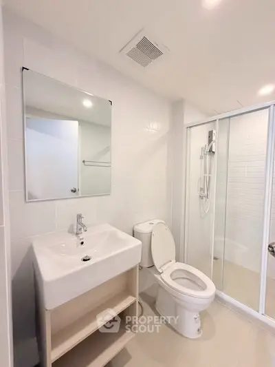 Modern bathroom with sleek fixtures and spacious shower in a contemporary home.