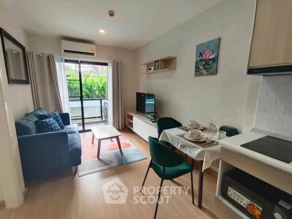 Modern living room with cozy seating and dining area, featuring natural light and stylish decor.