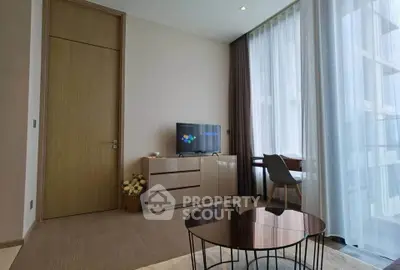 Modern living room with stylish furniture and large windows offering natural light.
