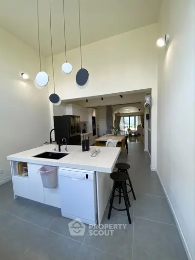 Modern open-layout kitchen with sleek island and stylish lighting