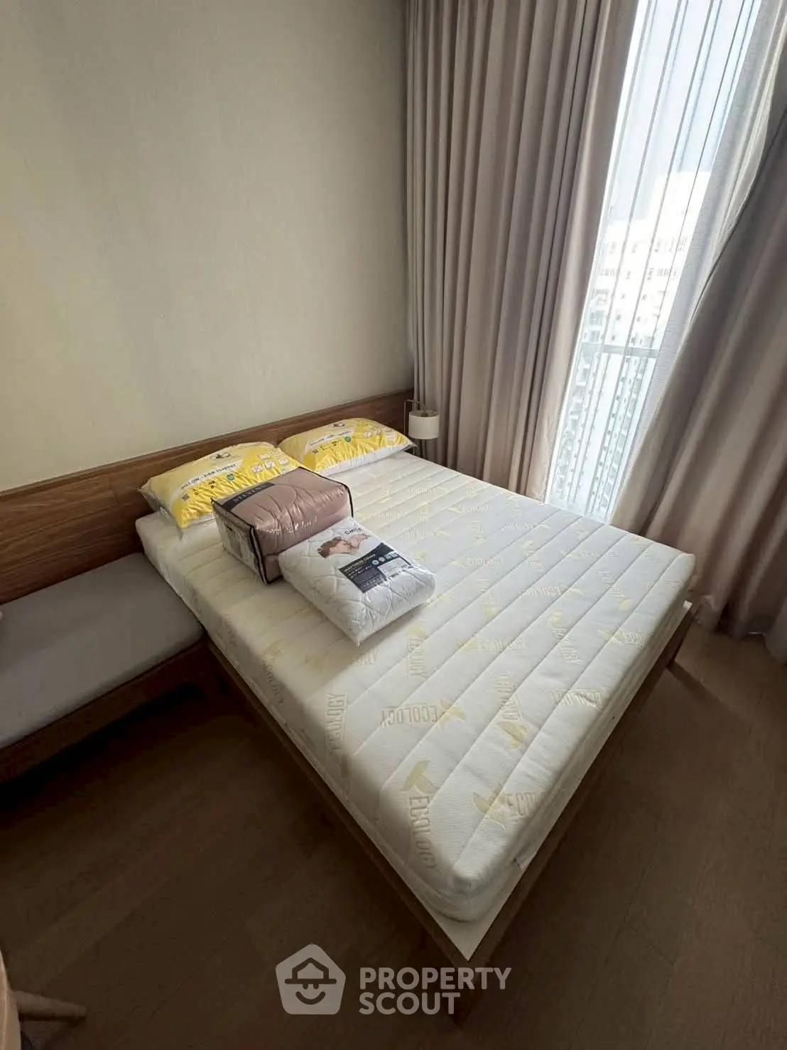 Cozy bedroom with natural light and modern furnishings, perfect for relaxation and comfort.