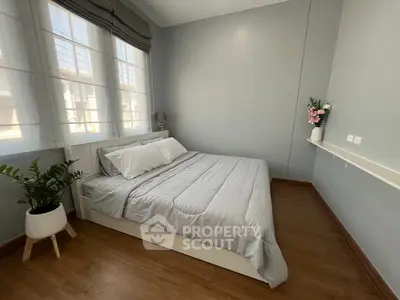 Cozy bedroom with modern decor and large windows for natural light