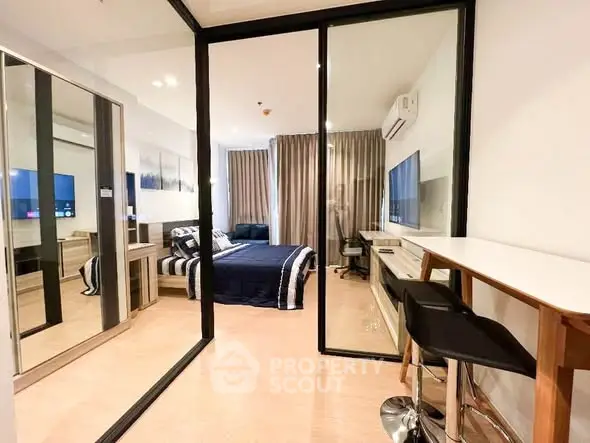 Modern bedroom with glass partition and stylish decor in a contemporary apartment.