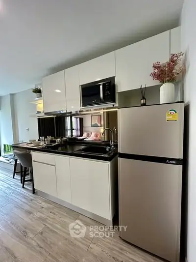 Modern kitchen with sleek cabinetry and stainless steel appliances in open layout