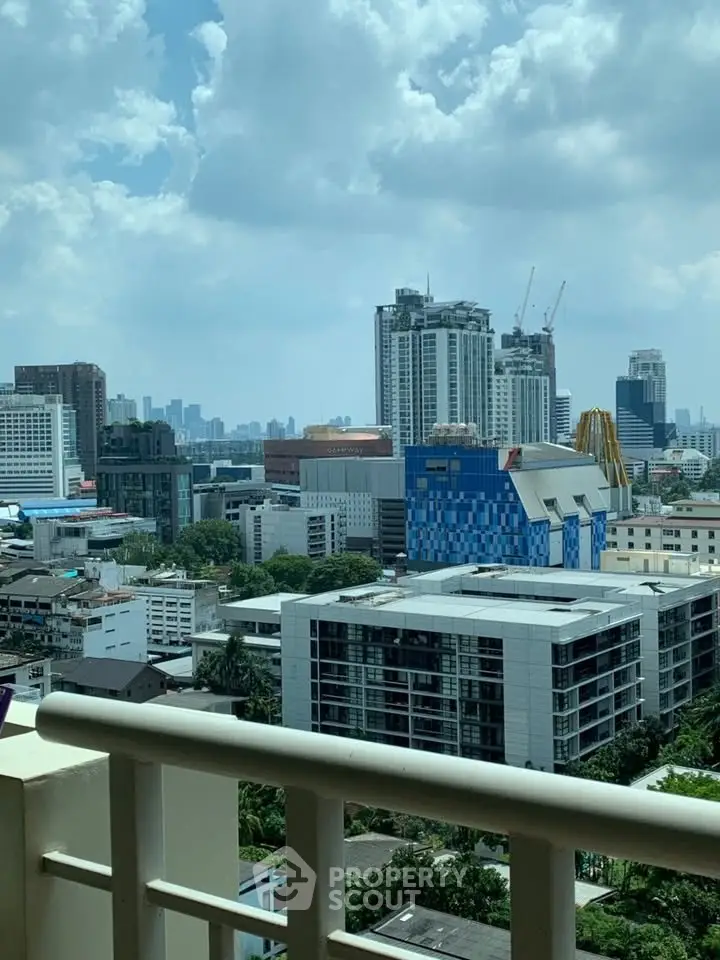 Stunning cityscape view from a high-rise balcony showcasing modern urban architecture.