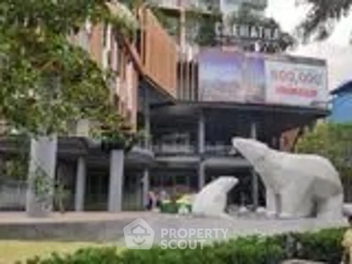 Modern building exterior with polar bear sculptures and lush greenery