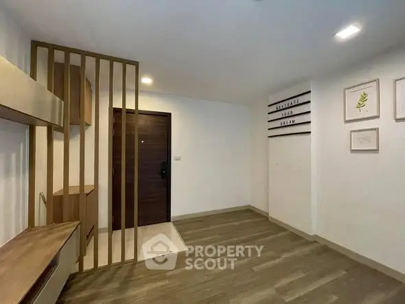 Modern minimalist entrance with wooden flooring and stylish decor