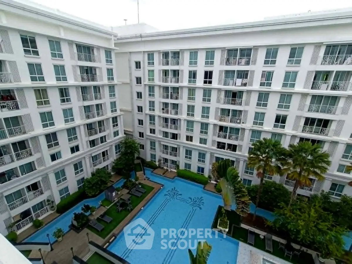 Luxurious condominium with stunning pool and lush garden view