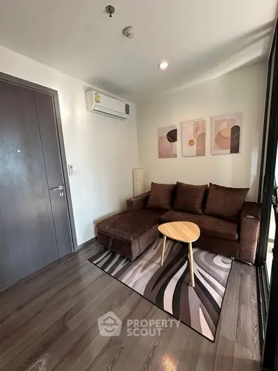 Modern living room with stylish brown sofa and abstract art on wall