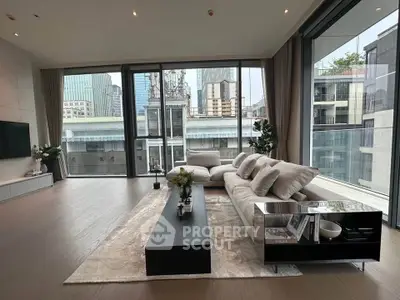 Luxurious modern living room with floor-to-ceiling windows and stunning city view.