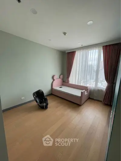 Charming children's bedroom with pink bed and city view, perfect for a cozy and playful living space.