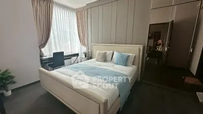 Modern bedroom with elegant decor and large window for natural light