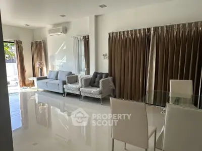 Spacious modern living room with elegant furniture and large windows for natural light.