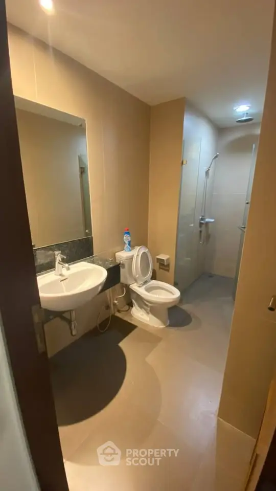 Modern bathroom with sleek fixtures and spacious shower area