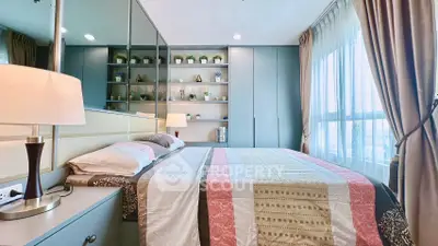 Elegant bedroom with modern decor and large window for natural light.