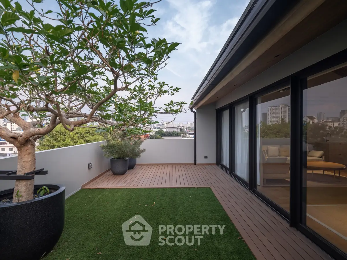 Stunning rooftop terrace with lush greenery and city views, perfect for relaxation and entertainment.