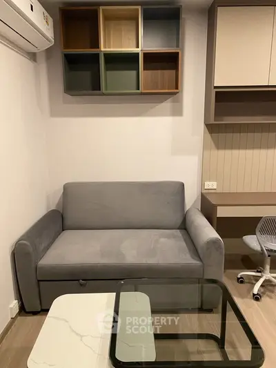 Modern living room with stylish sofa and shelving, perfect for cozy relaxation.