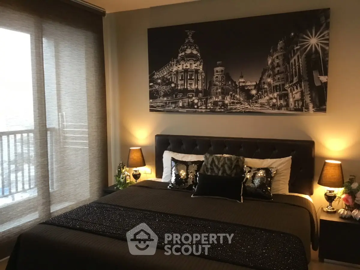 Luxurious bedroom with elegant decor and cityscape artwork, featuring a cozy bed and ambient lighting.