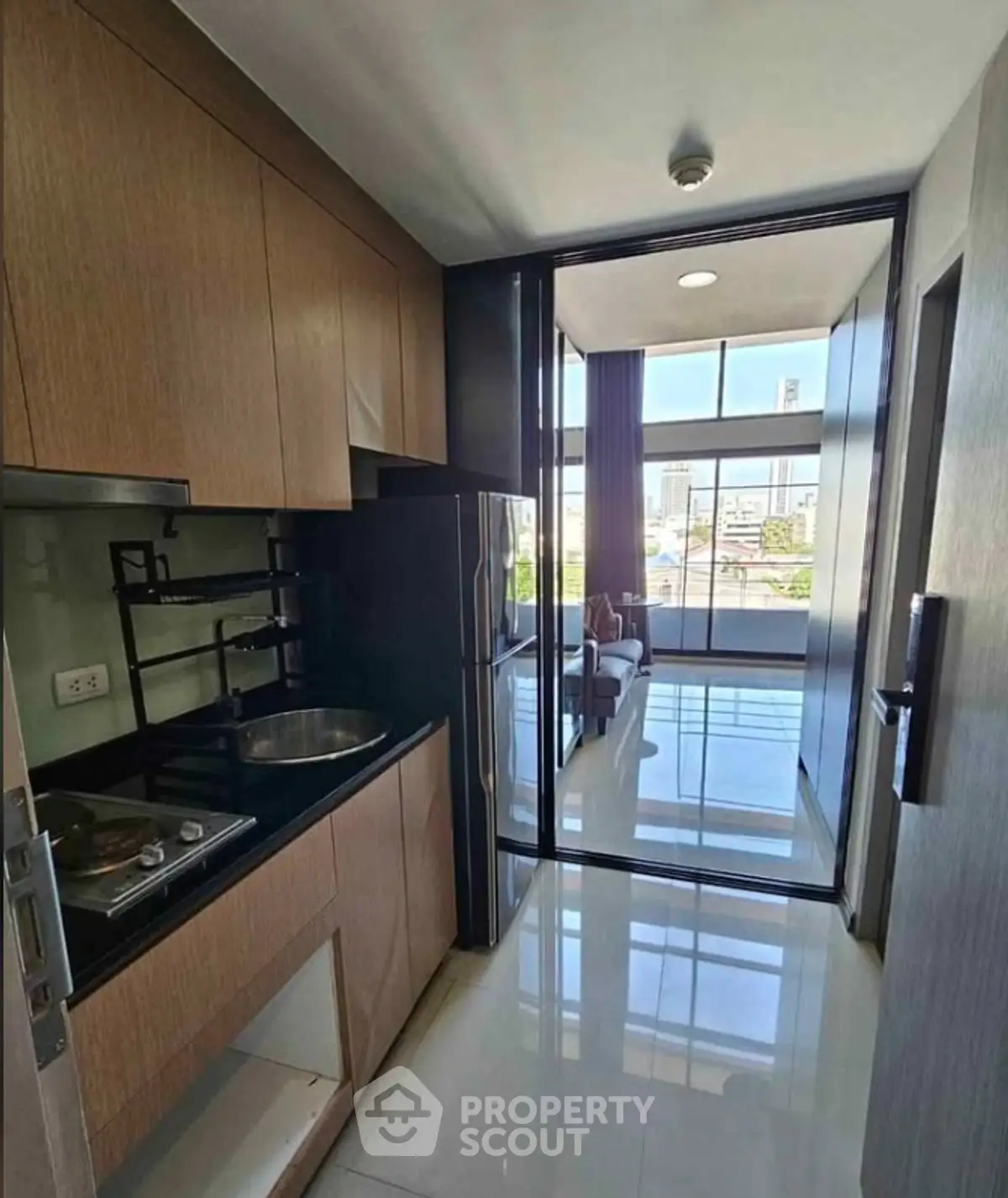 Modern kitchen with sleek design and city view in high-rise apartment